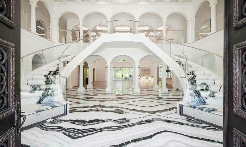 Stairwell of a mansion covered in white and black marble