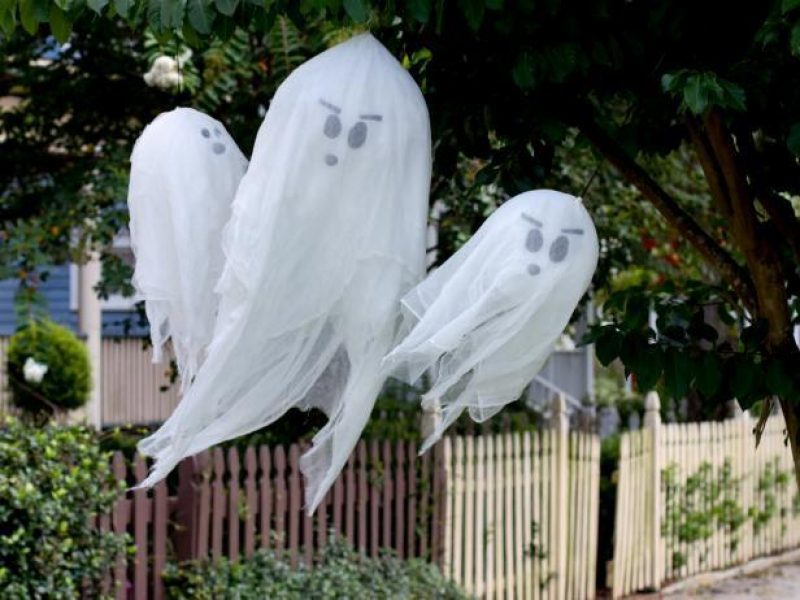 homemade ghosts on a fence