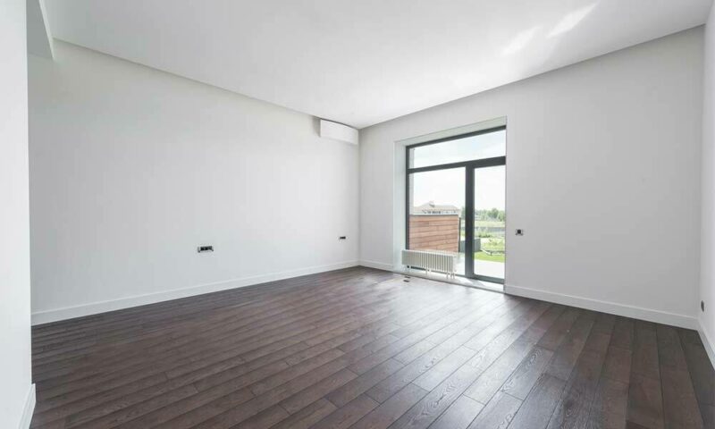 Bare room with white walls and dark hardwood floors