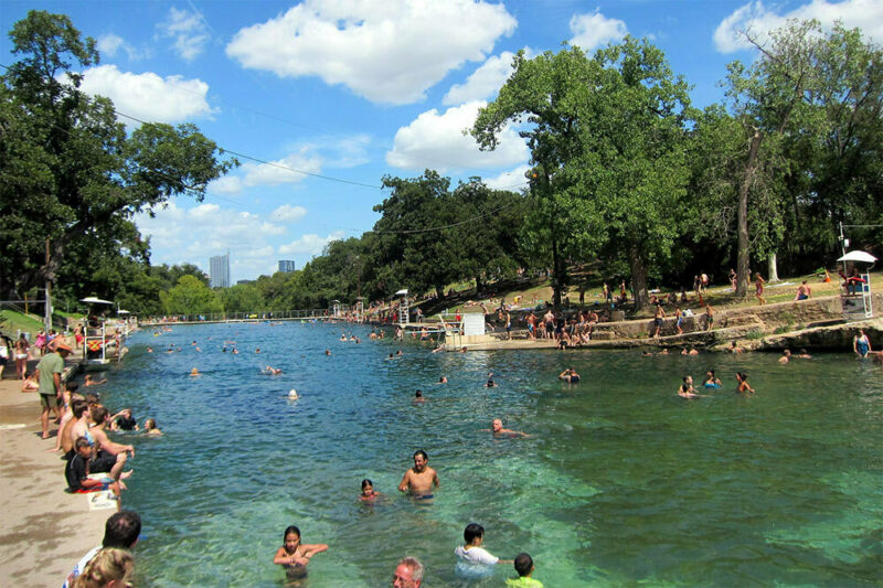 people swimming at Barton Springs Pool at Zilker Park in Austin, TX