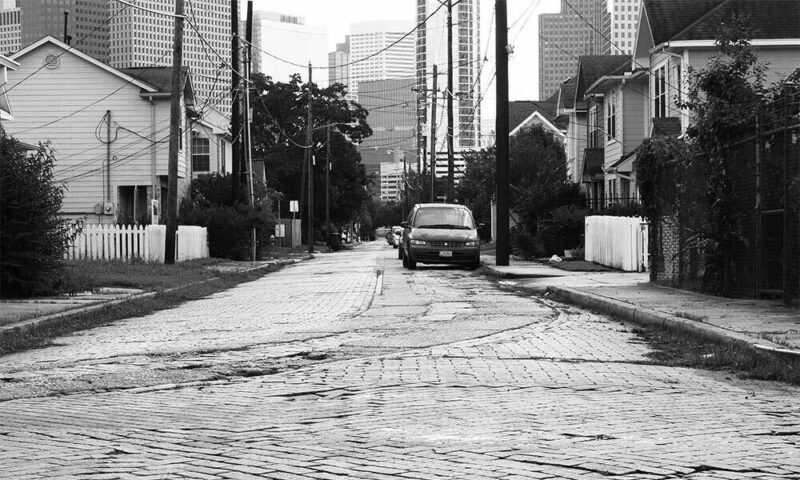 Black and white image of a city street.