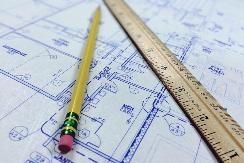 blueprints with a ruler and a pencil