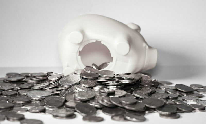 open piggy bank with coins spilling out