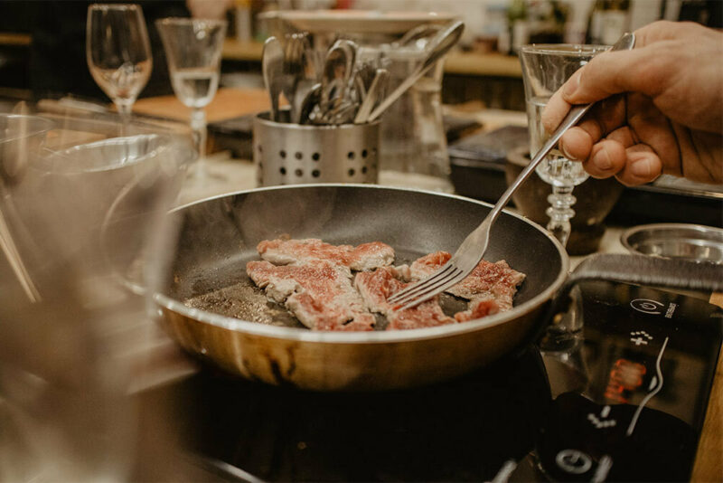 cooking meat in a pan