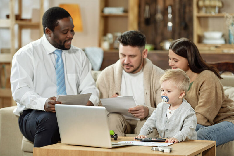 4 people looking at laptop