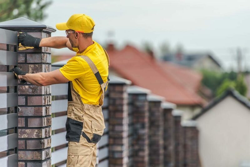 man installing a decorative fence