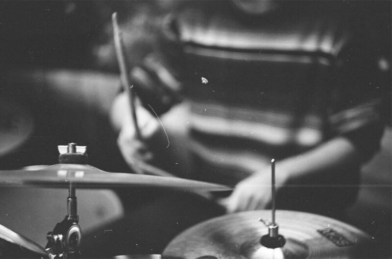 close up of boy playing drums