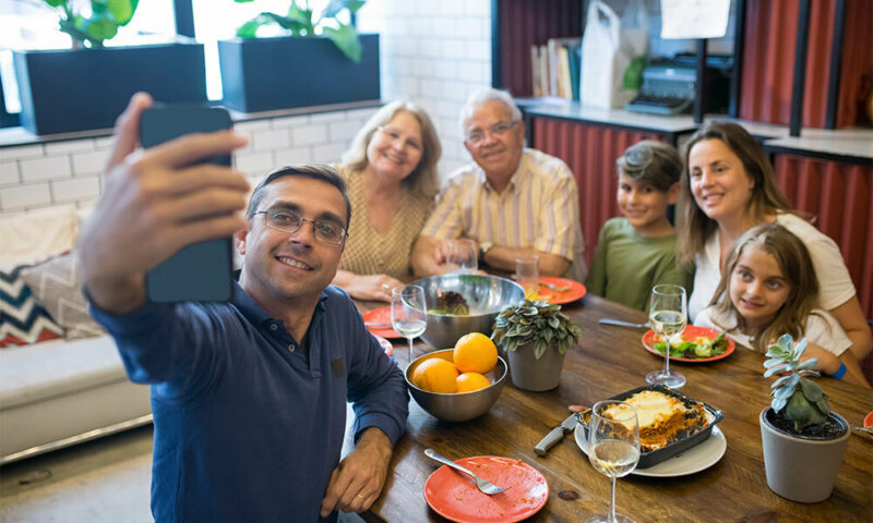 family taking a selfie at the dinner table