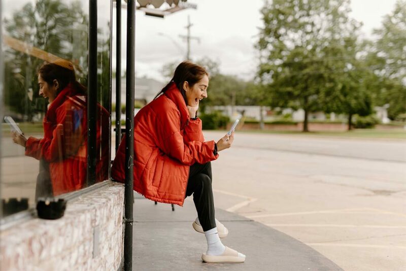 Teenage girl using phone to FaceTime her friends back home