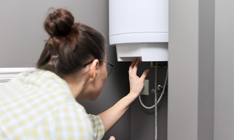 Woman adjusting water heater