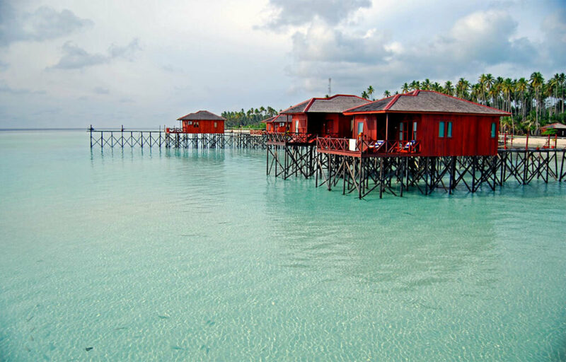 Red beachfront houses on the water