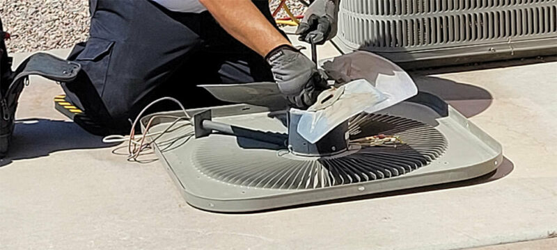 HVAC technician working on an AC unit