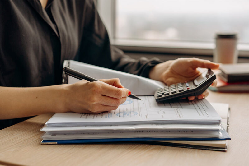 woman with a calculator and pad of paper