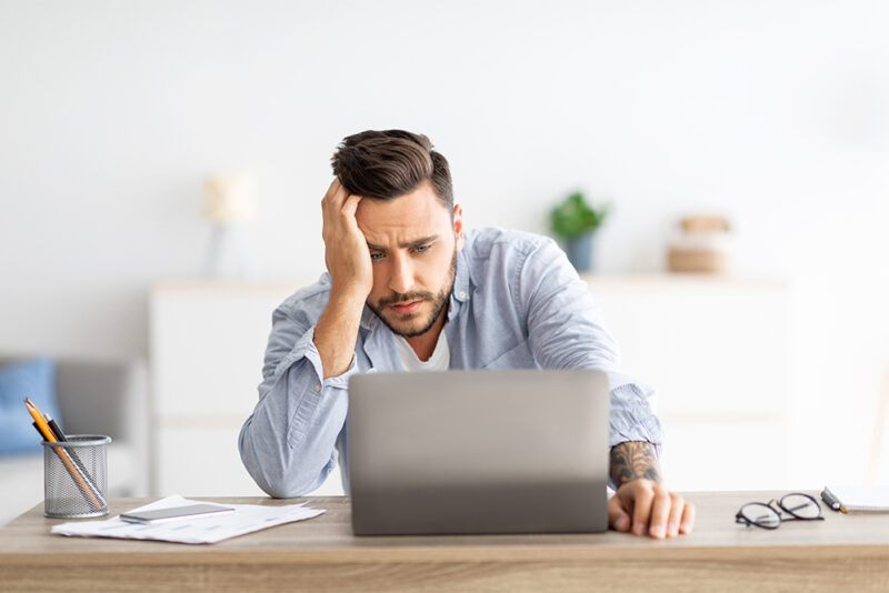 stressed man working with his laptop