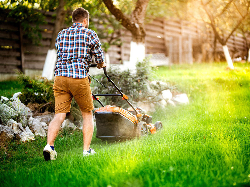 man pushing lawnmower