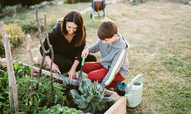 mom and son working in garden