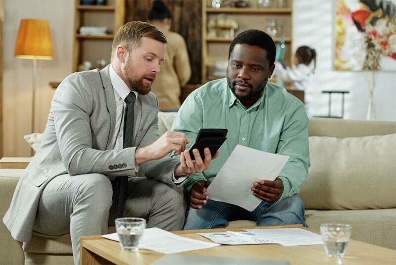 Man speaking with his mortgage adviser about monthly payments