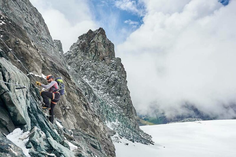 Man climbing a snow-capped mountain