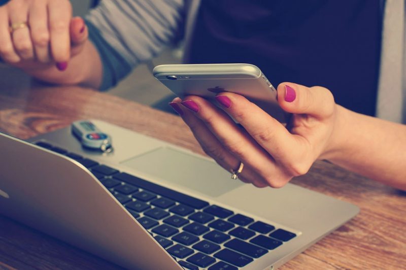 Woman checking out mortgage rates on her laptop and cell phone