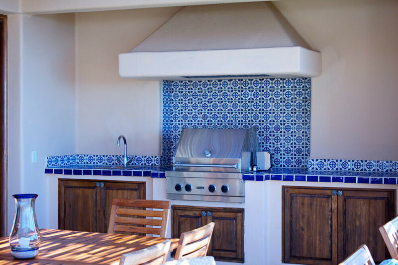outdoor kitchen with blue and white tile backsplash