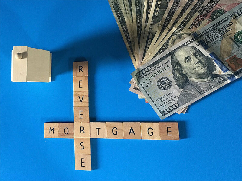 Reverse Mortgage Scrabble tiles next to pile of cash