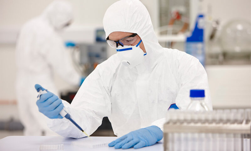 Scientist working in a lab in personal protective equipment.