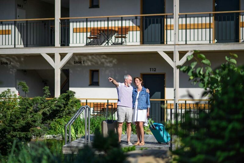 man and woman standing outside an apartment