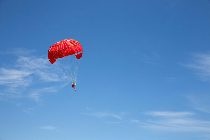 skydiving with red parachute