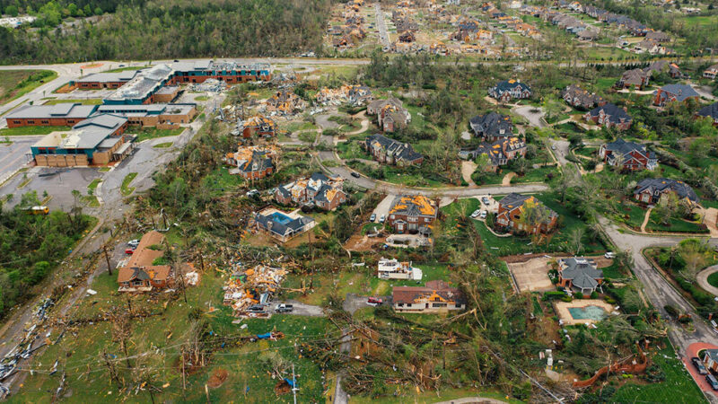 aerial shot showing storm damage in a neighborhood