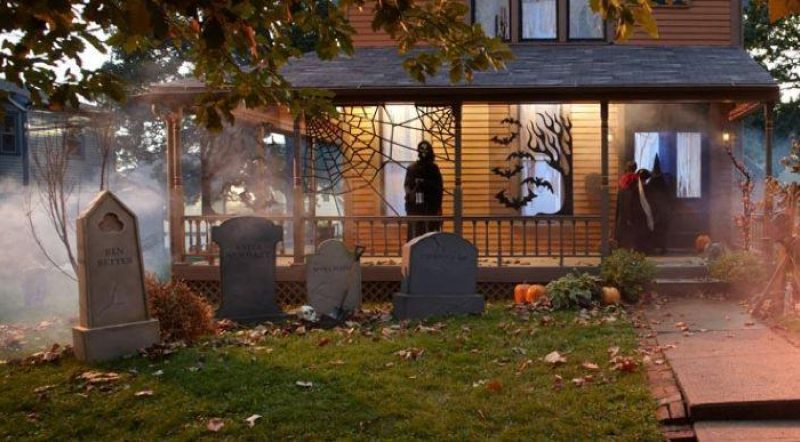 house with cemetery headstones in yard