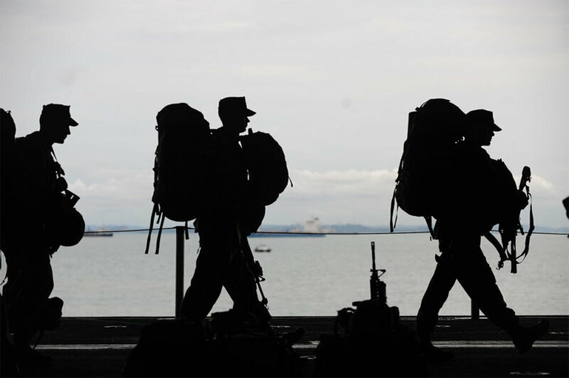 troops walking with their backpacks