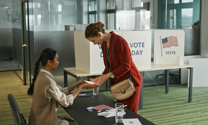 woman checking in at voting poll location