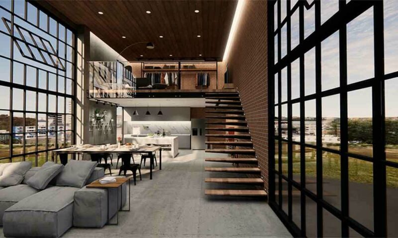 Brick condo with large industrial windows, concrete floors, a gray couch and stairs.