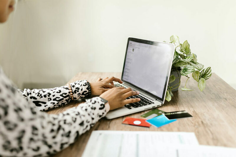 woman using computer and credit cards