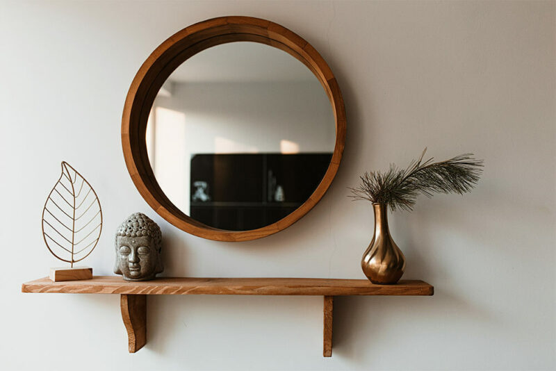 wooden mirror hanging on wall
