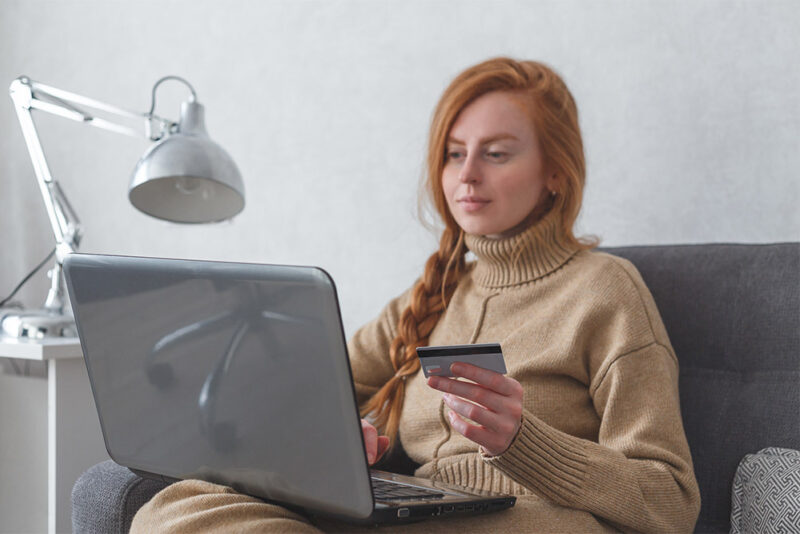 Young woman with laptop and credit card